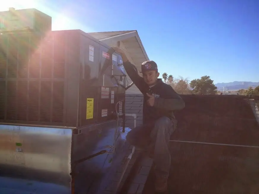 HVAC technician performing AC Tune-Up on a rooftop unit in Goose Creek
